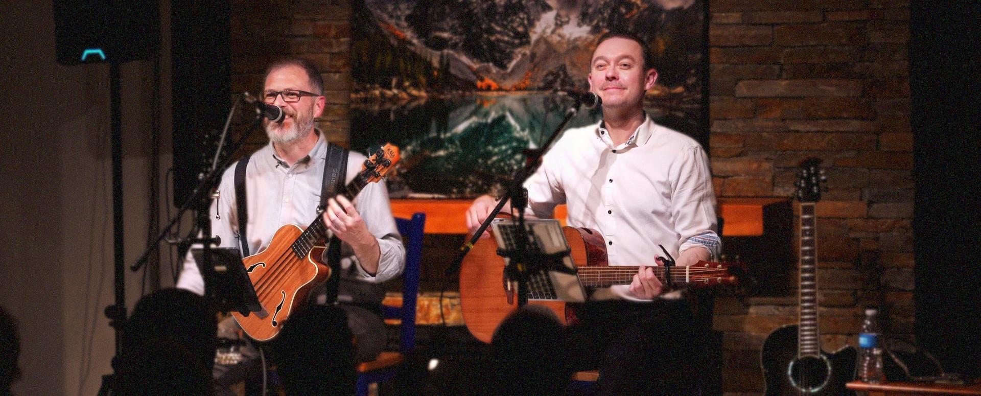 Dave and Tom performing live in a warm candlelit listening room
