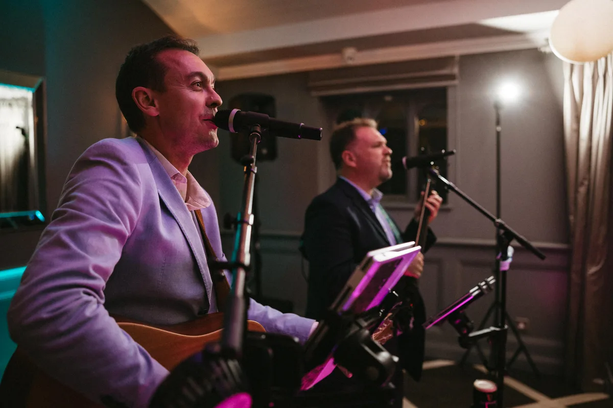 Dave and Tom performing together at an intimate wedding reception